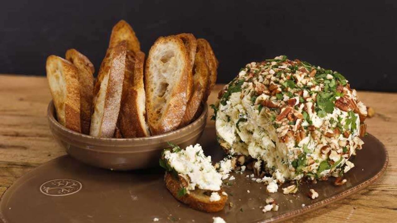 Premium Photo  Cheese balls with garlic and dill inside for a snack in a  plate on a black background.