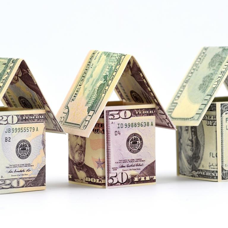 houses made out of $20, $50 and $100 bills
