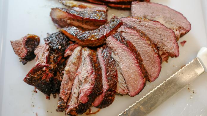 Andrew Zimmern - End of a black bear brisket in front, piece of